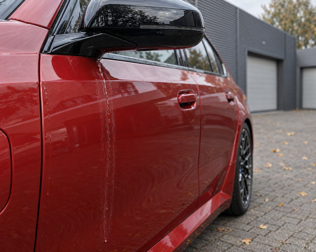 Detailing1 dry your car — run-off water from the mirror drags mineral rings across the door of a red BMW M5