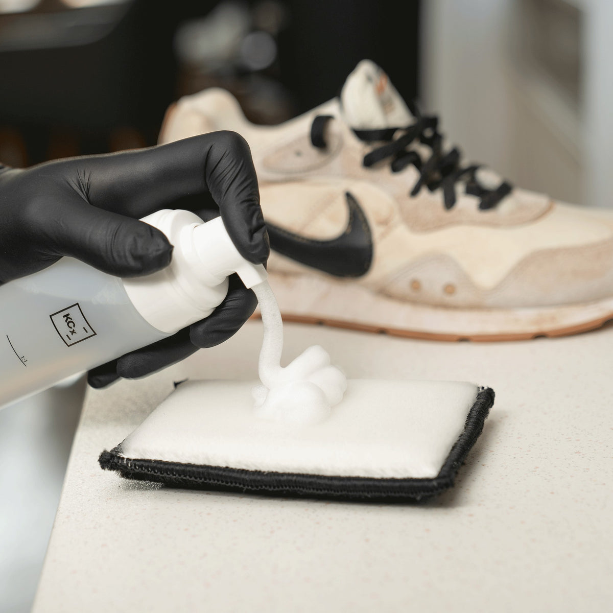 Detailing1 COLOURLOCK Sneaker Cleaner — cleaning foam on the pad, the dirty sneaker behind it